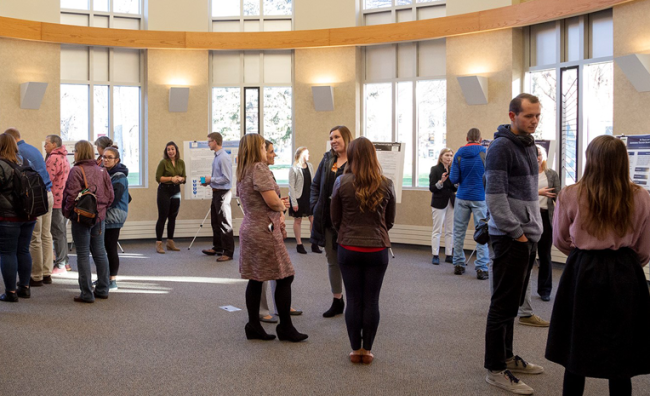Students and faculty attending a research poster session