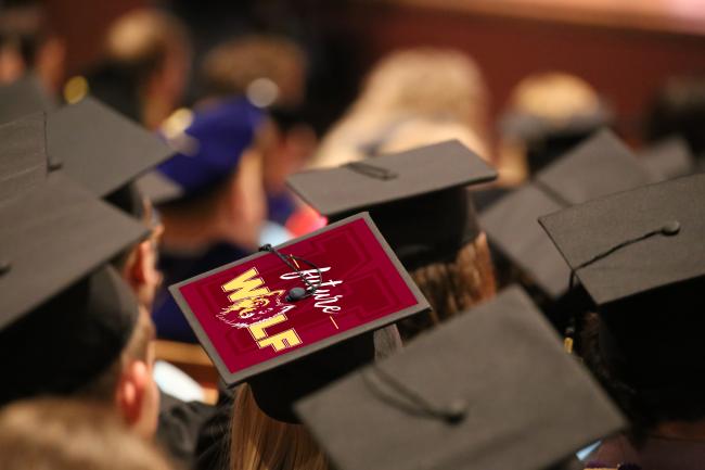 Grad caps from behind at commencement