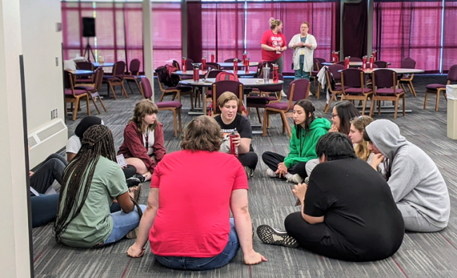 Upward Bound students sitting in a circle talking at NSU