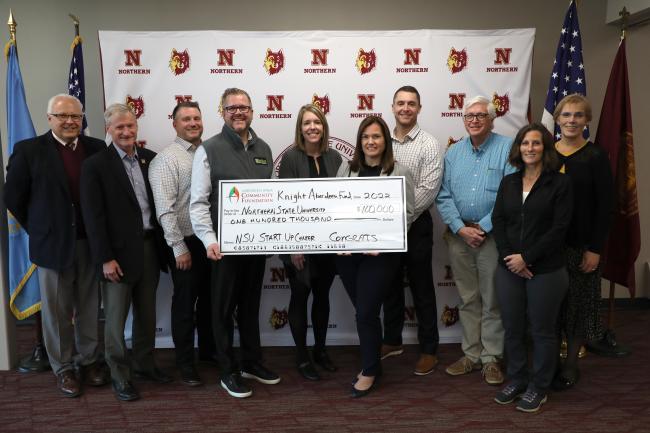 Photo of NSU officials receiving a large, symbolic check from grant recipient, Knight Foundation's Aberdeen Fund