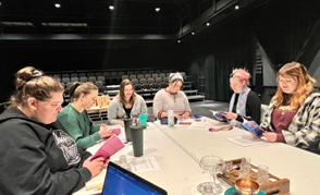 NSU Theatre students reading through scripts in the Black Box Theater