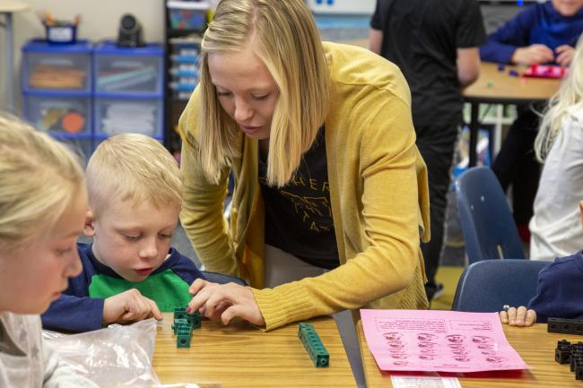 A student teacher from NSU works with children in the classroom