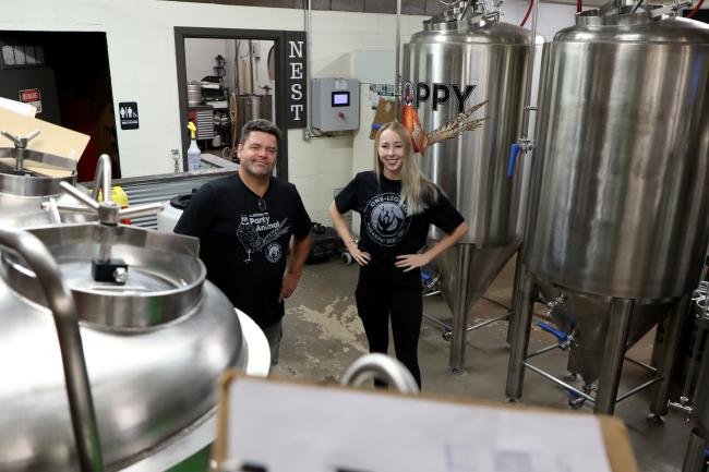 Dave Welling and Jess Splichal stand in the brewing room of One Legged Pheasant