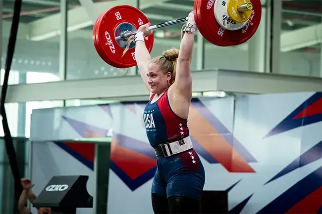 Katie Witte lifting weights over her head